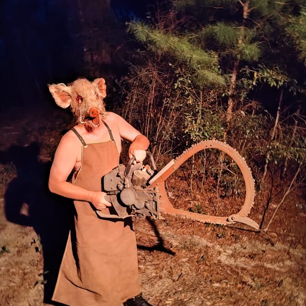 Pork Chop holding a scary chainsaw